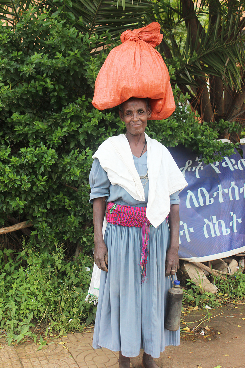 Ethiopian woman carrying a large bundle on her head